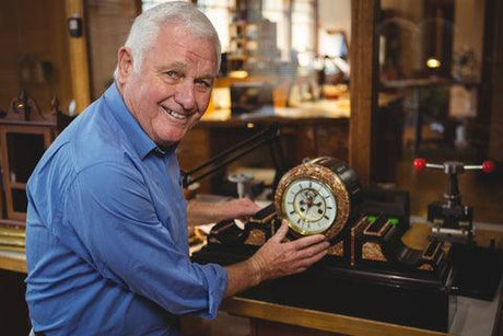 a clock maker in a workshop