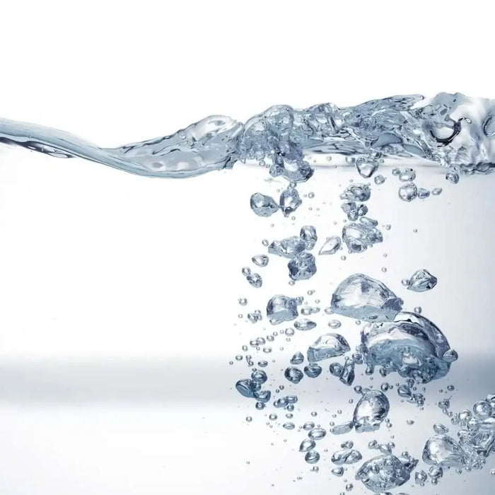 Clear water with bubbles and a wave on a white background