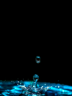 Water droplets landing in water